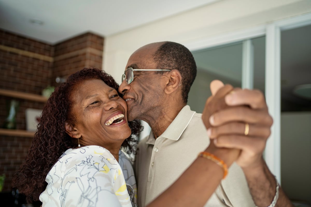Happy senior couple dancing on balcony customer review