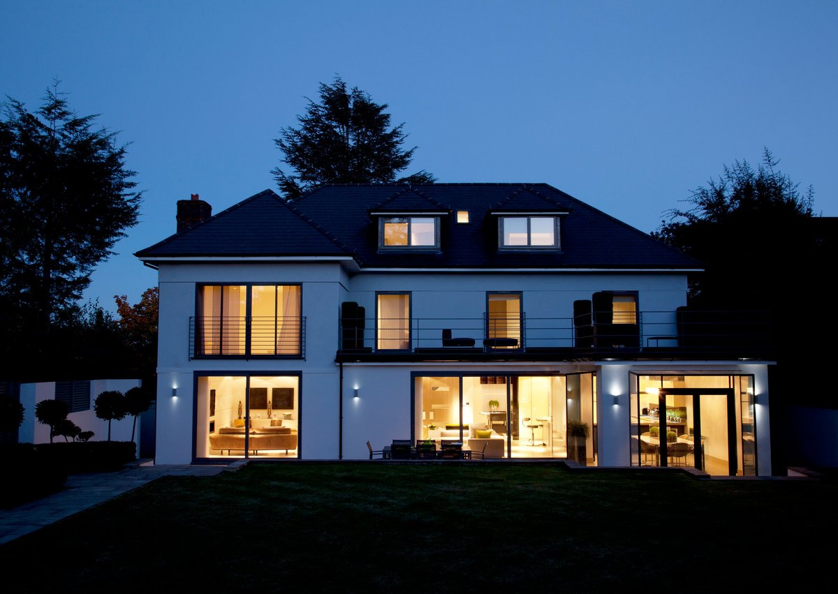 Modern two-story house with Govee lighting and patio at dusk