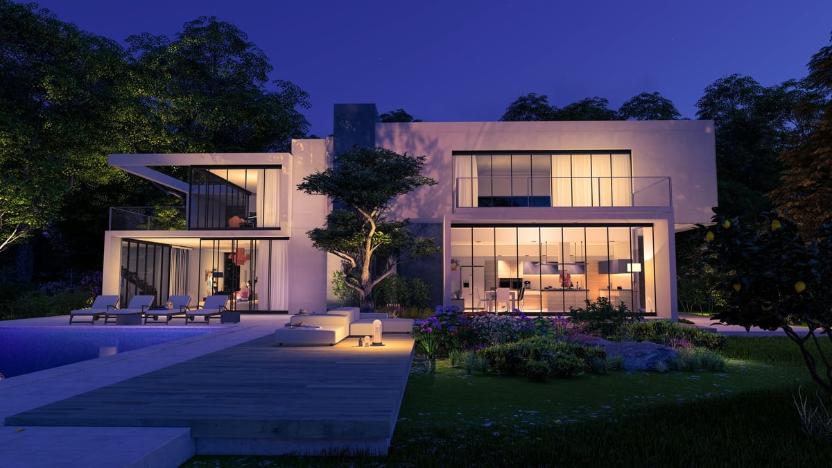 Contemporary cubic house with garden and lounge area by the pool in the evening