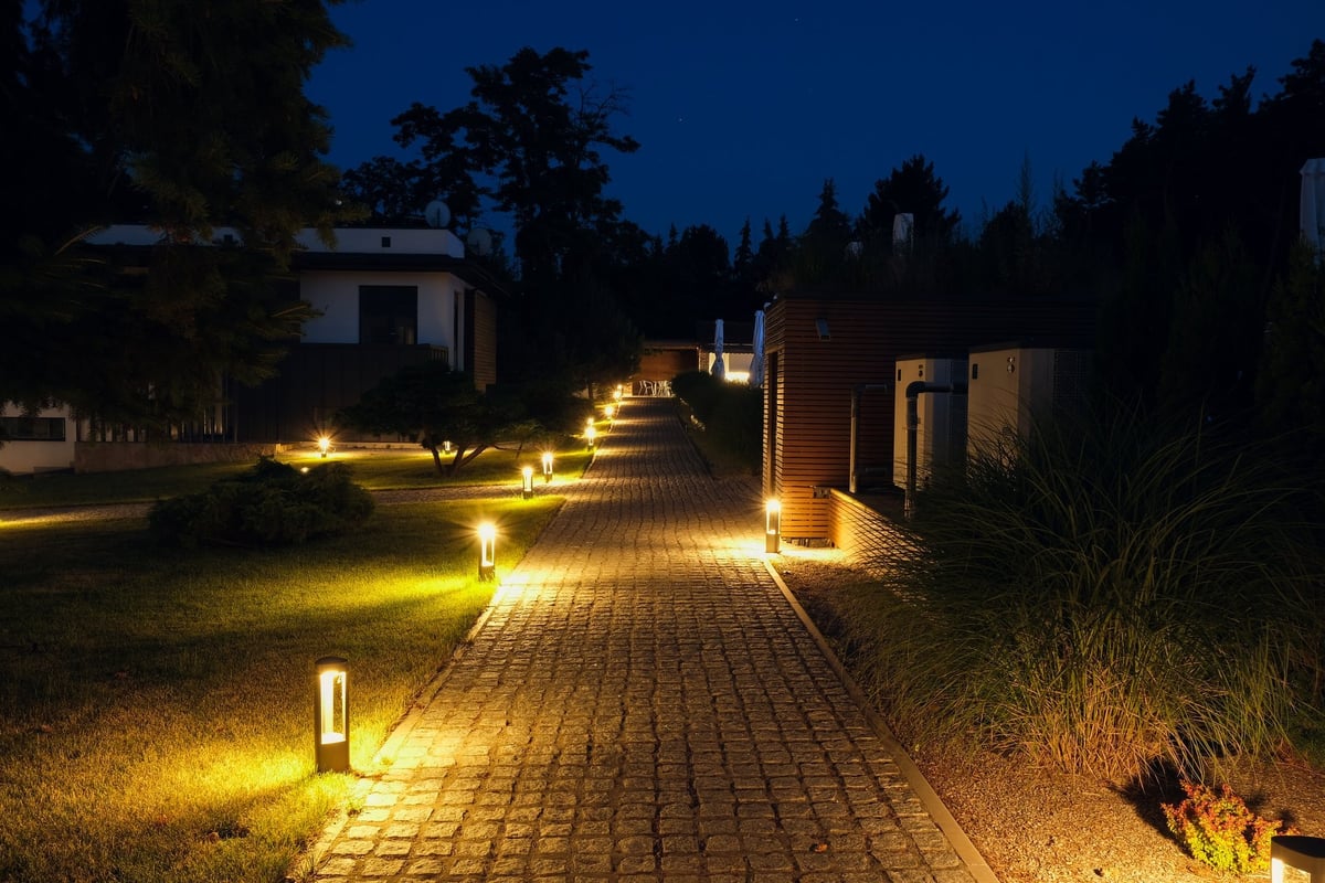 Alley, stone path in a country residence illuminated by street lamps