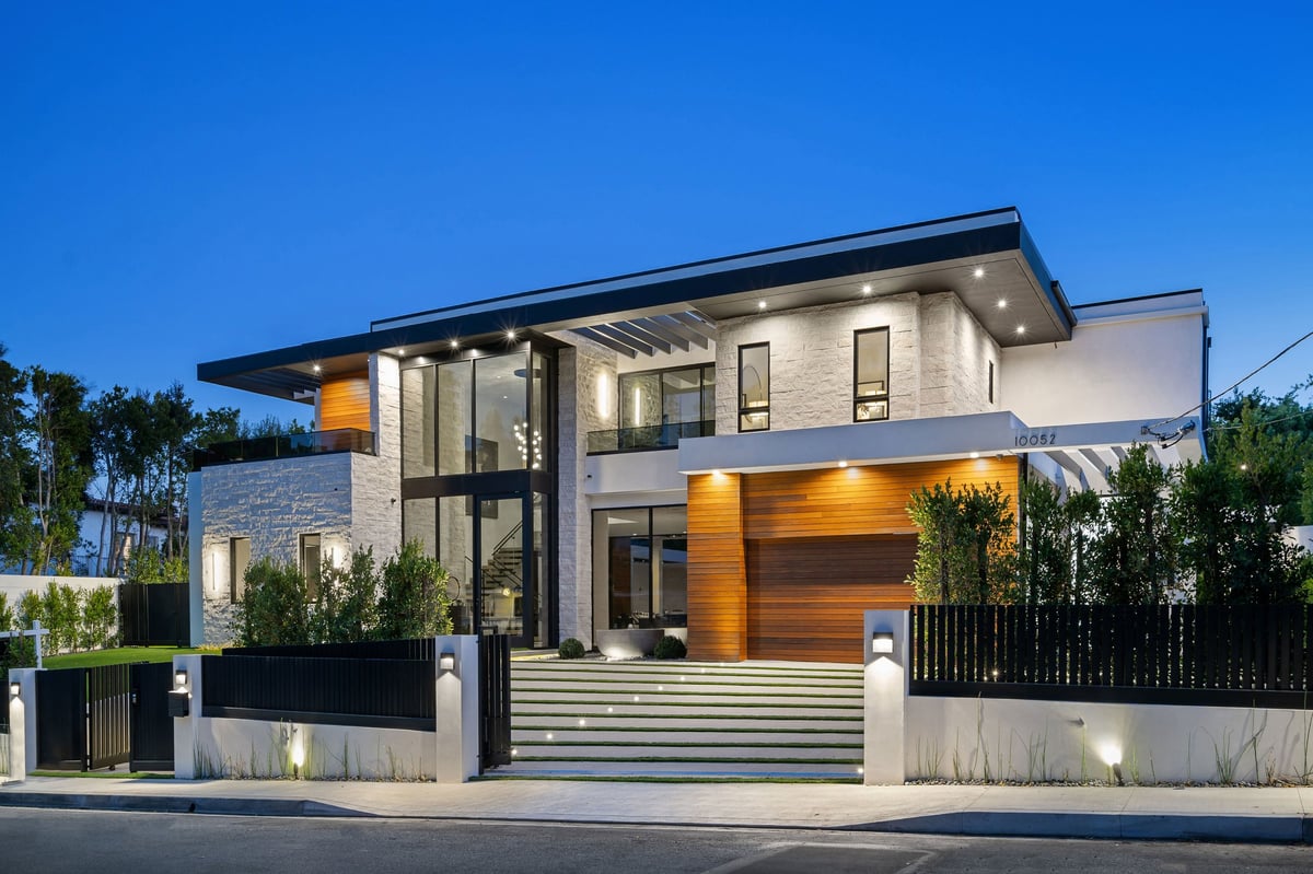 Modern luxury house exterior with large windows and evening LED lighting