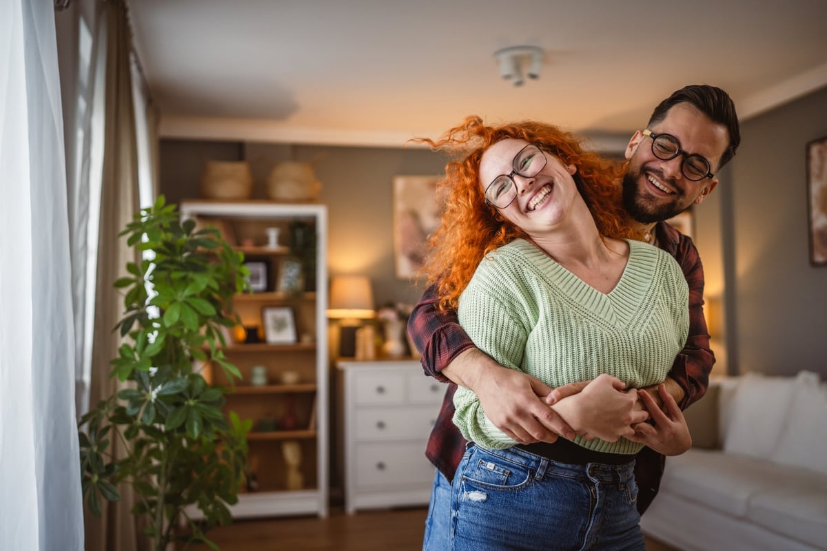 Man and woman couple in love dancing and hugging at home customer review