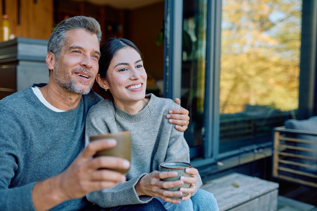 Happy couple embracing on home terrace customer review