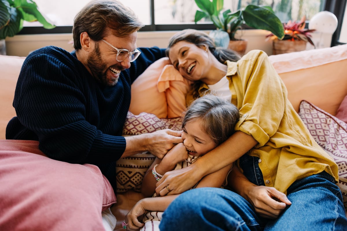 Happy family lounging on a sofa at home customer review