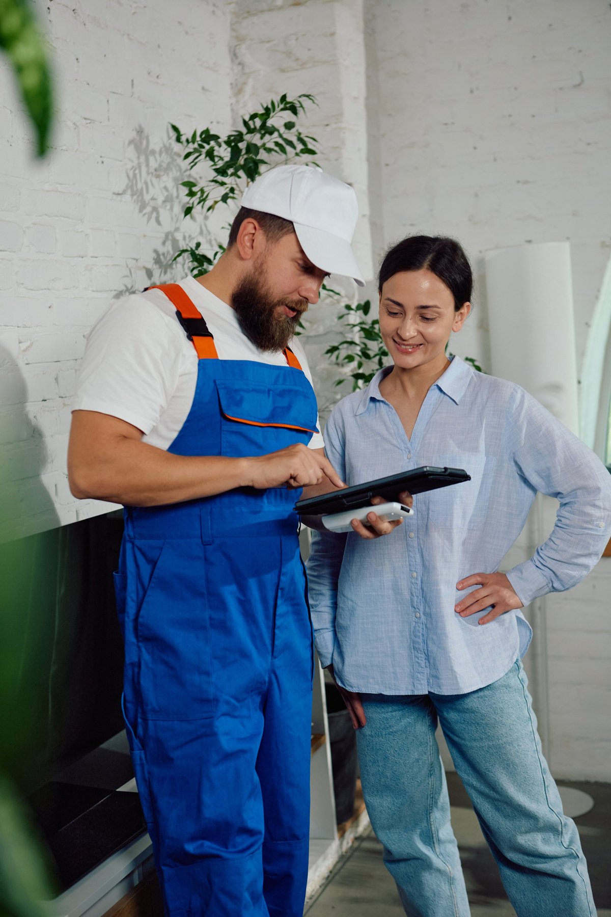 Technician smiling while explaining to homeowner customer review