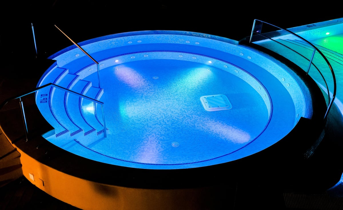 Warm outdoor resort hot tub at night