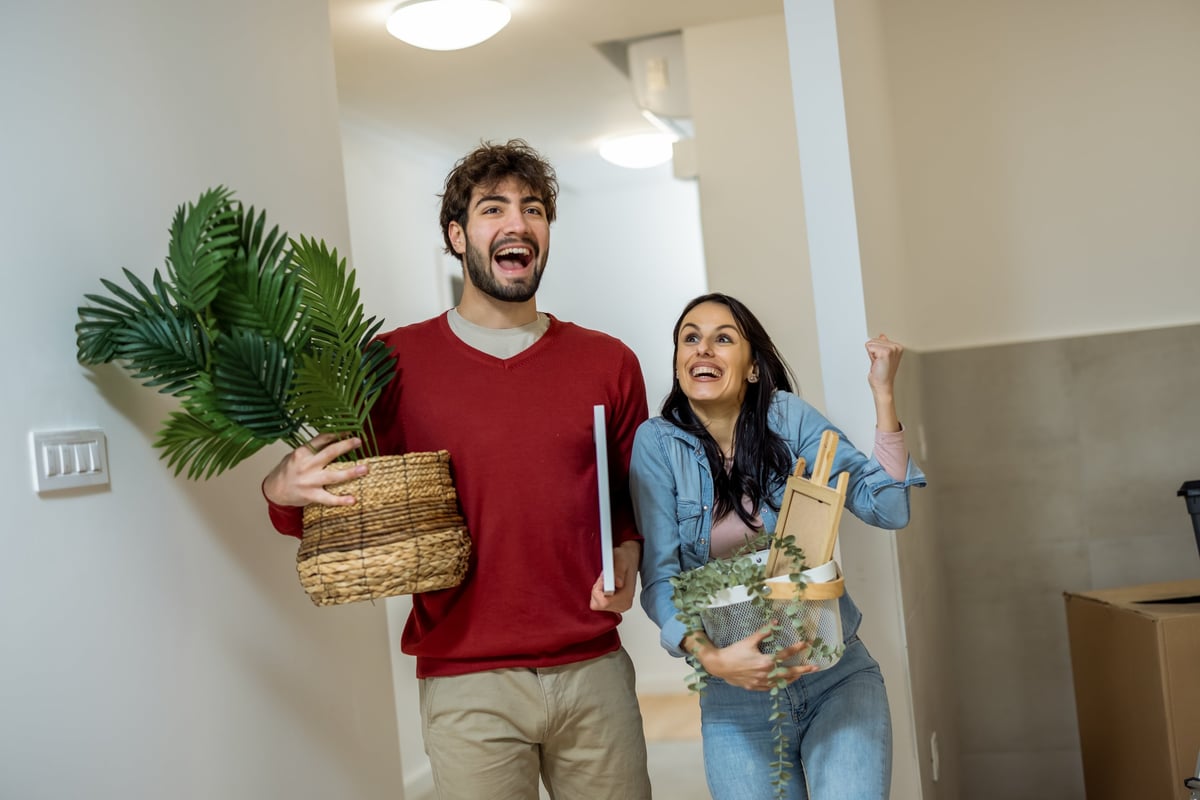 Man and woman embracing among cardboard boxes customer review