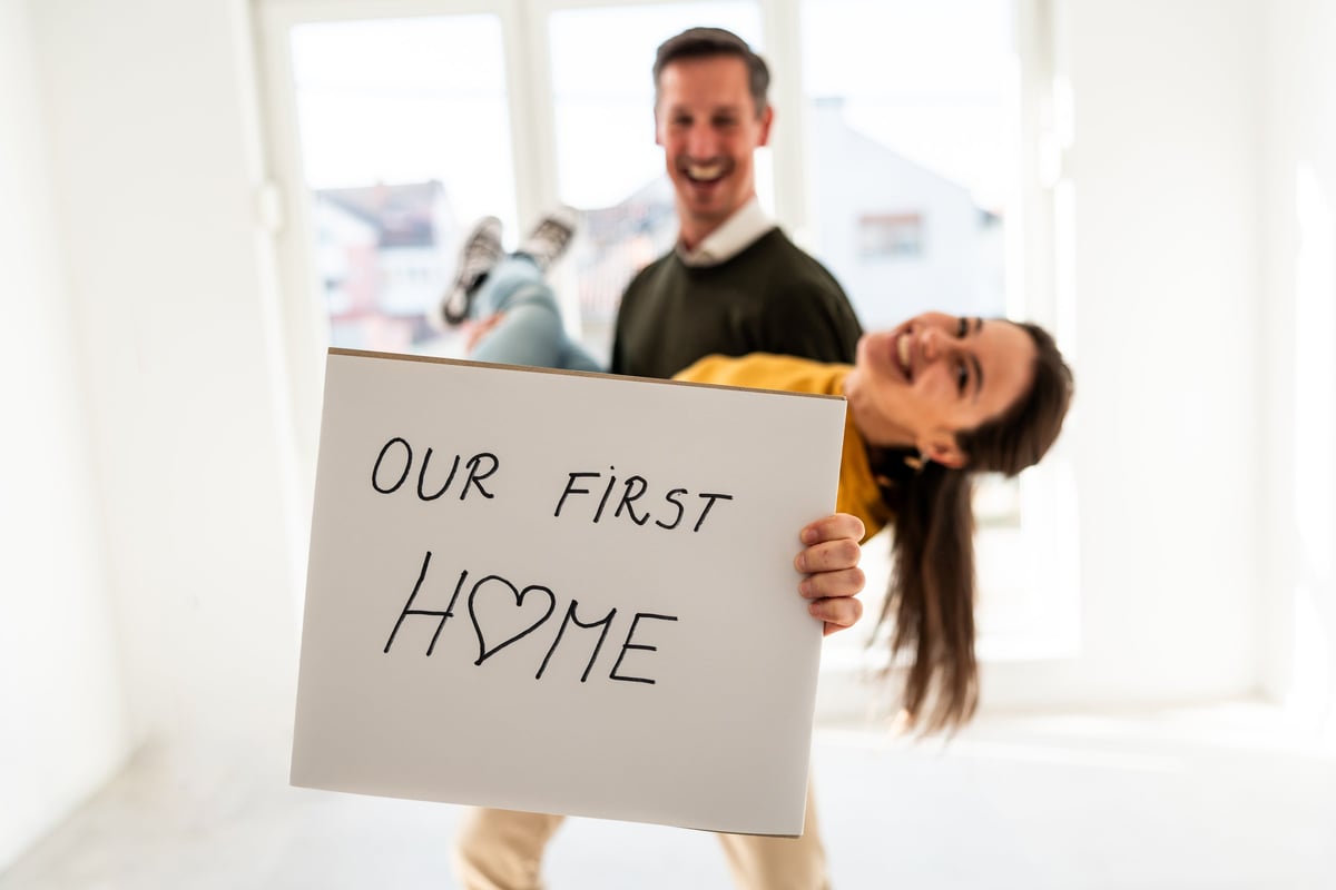 Joyful young couple celebrating their first home customer review