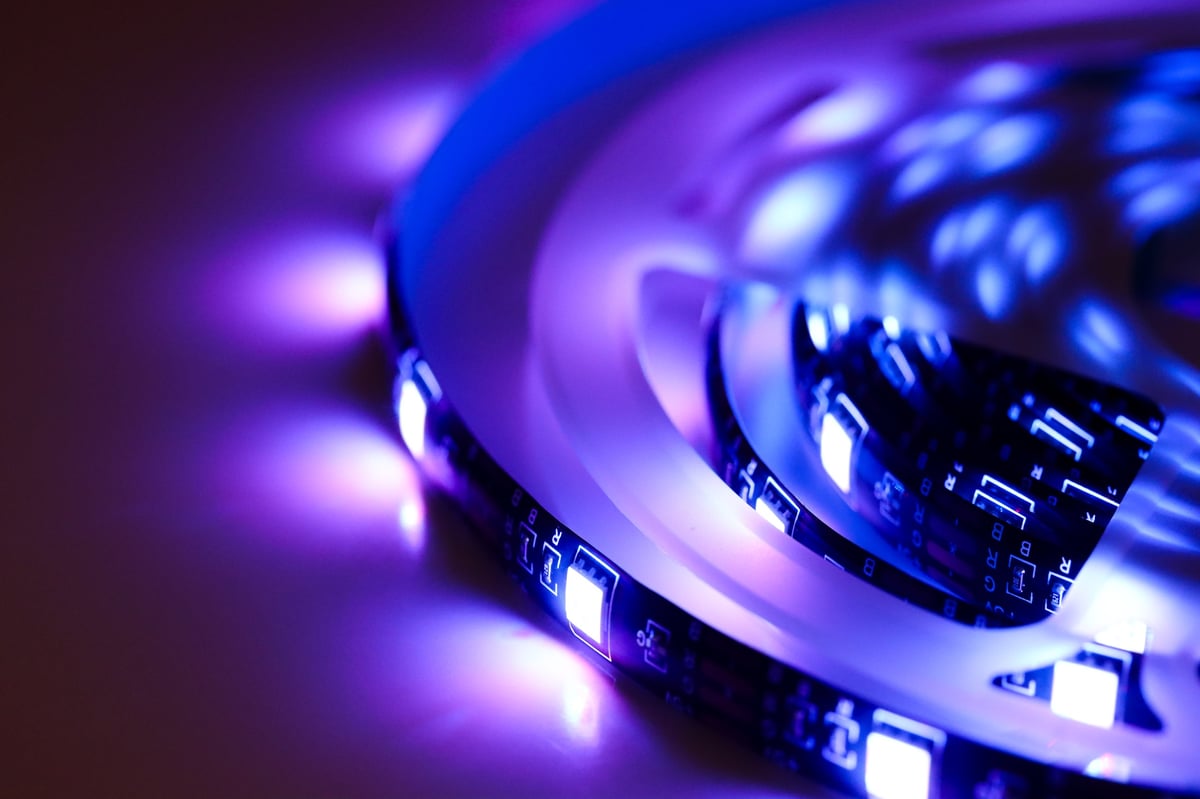 Close-up of a blue LED strip light glowing in a dark environment