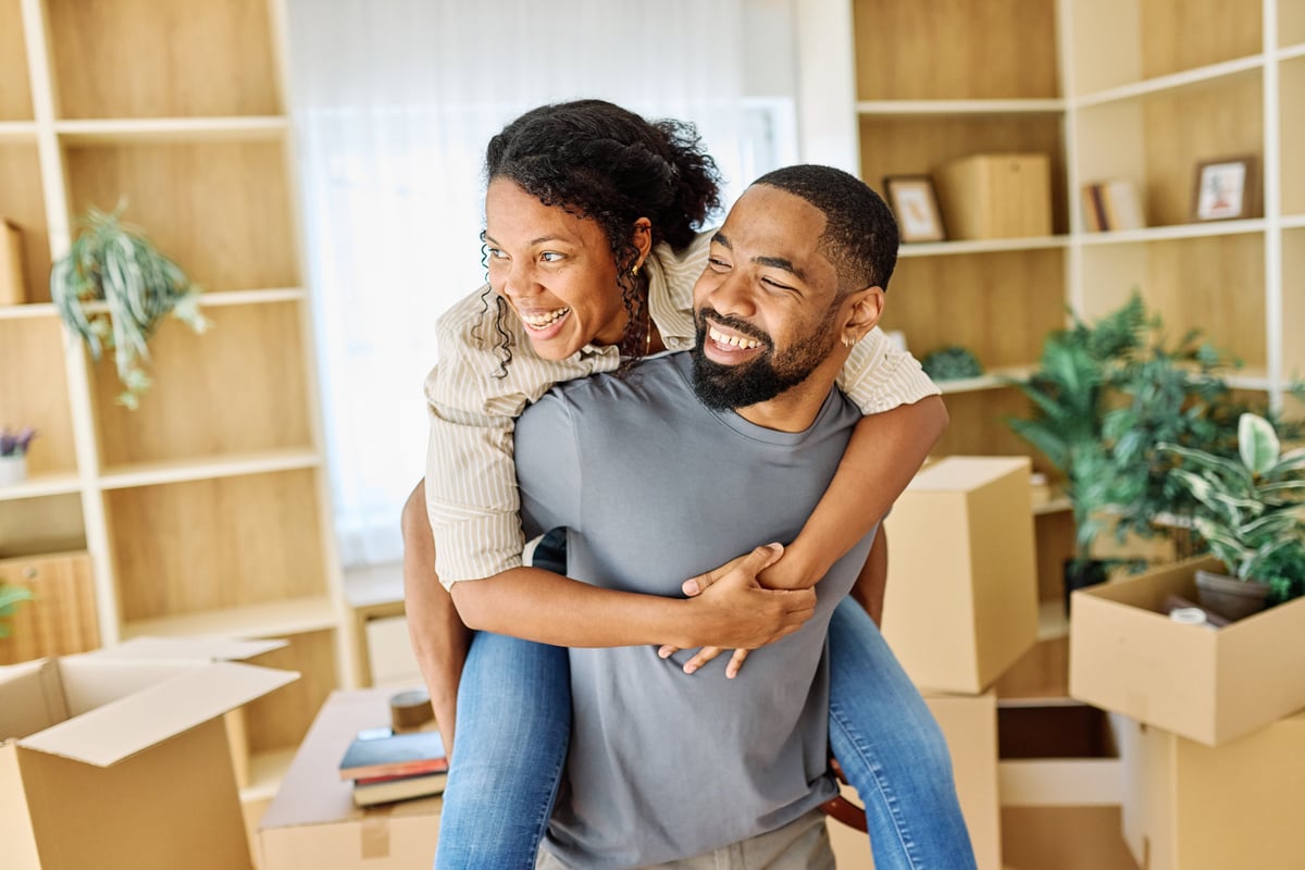 Portrait of young couple unpacking in a new apartment customer review