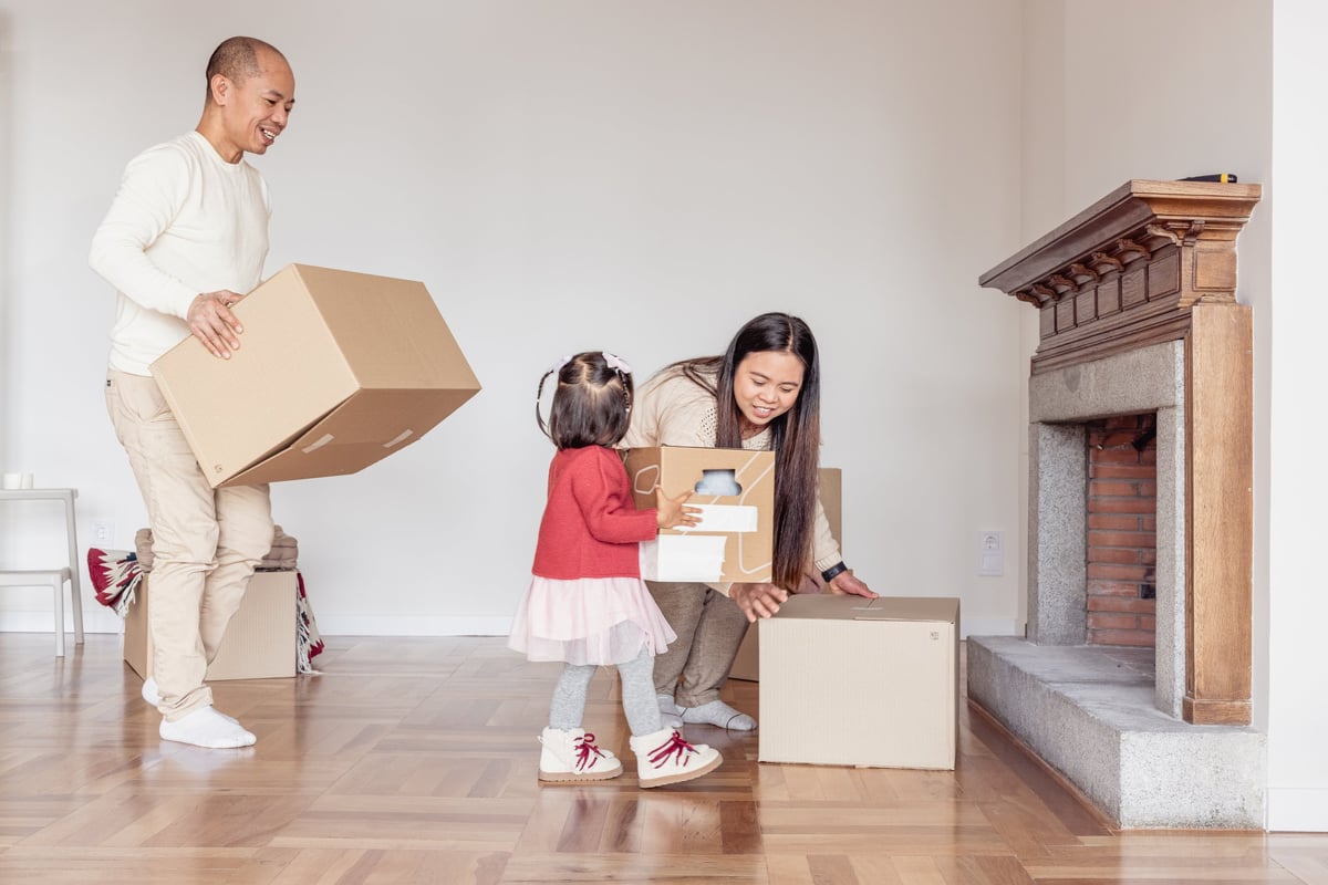 Happy family unpacking moving boxes in their new house customer review