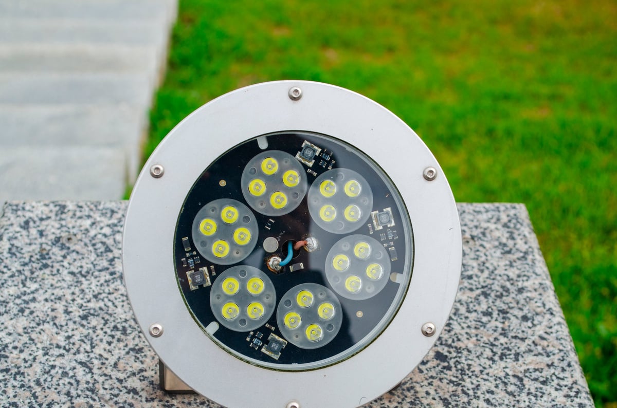Round LED light fixture with bulbs arranged in a circular pattern