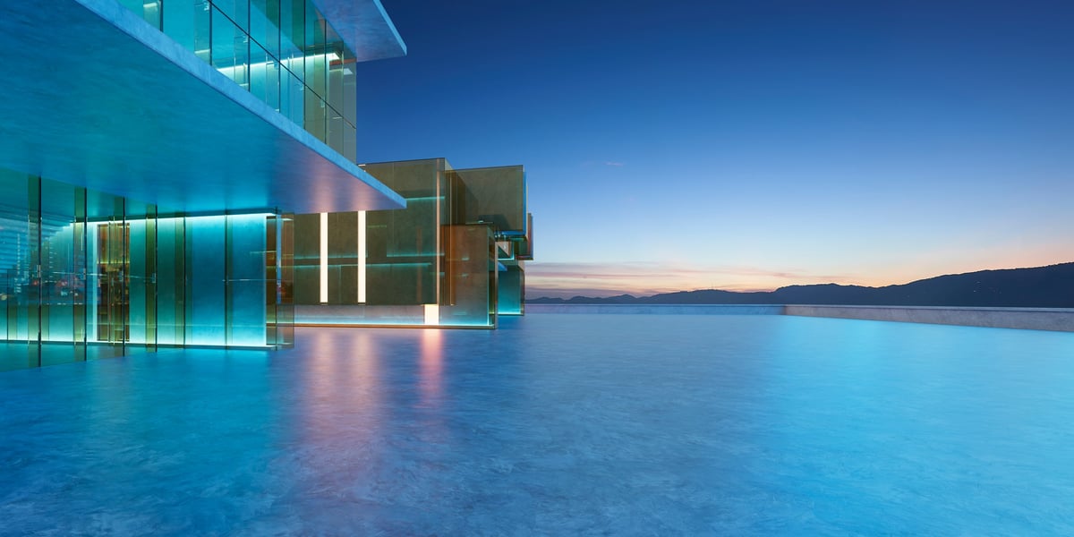 Luxury resort blending with an infinity pool under a serene twilight sky