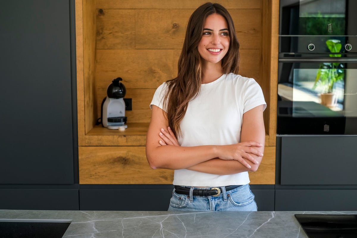 Young woman smiling confidently in her home customer review
