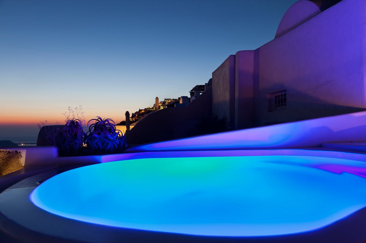 Colorful open air spa pool with colorful LEDs at dusk