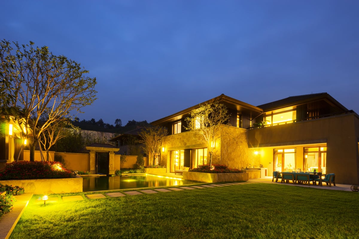 Govee exterior lighting on modern backyard and building reflecting water at night